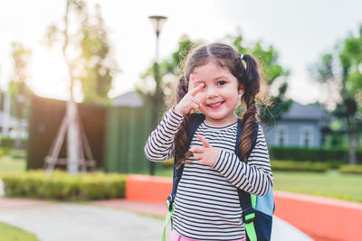 Portrait of smiling cute girl gesturing