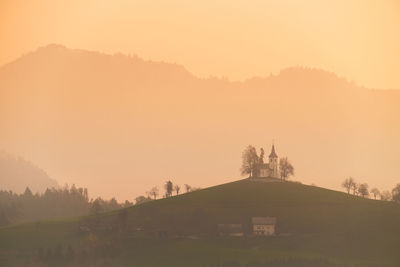 Scenic view of field against sky during sunset