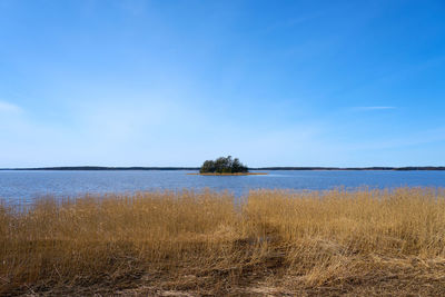Scenic view of sea against blue sky