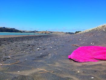 Scenic view of beach against clear blue sky