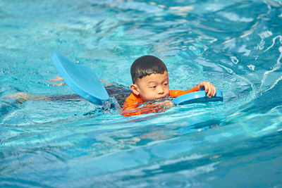 Boy swimming in pool
