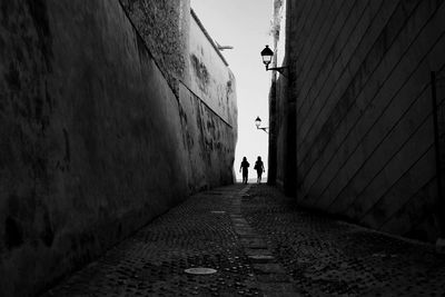 People walking on alley in city