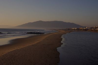 Scenic view of beach against sky during sunset