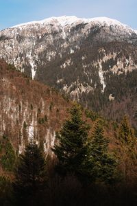 Scenic view of snowcapped rocky mountains against sky during winter