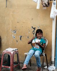 Portrait of boy sitting on seat