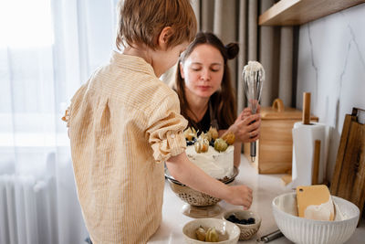 Portrait of happy woman standing by food