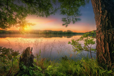 Scenic view of lake against sky during sunset