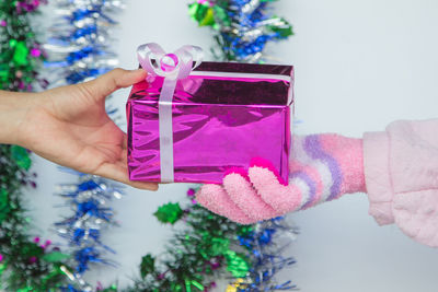 Cropped hands holding gift box during christmas