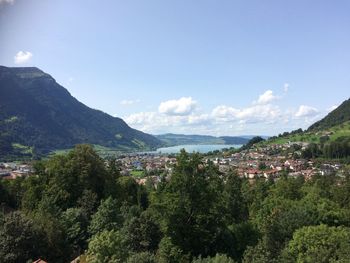 Town by mountains against sky