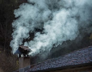 Smoke emitting from roof of building