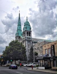 Buildings against cloudy sky