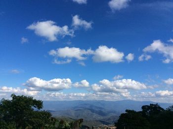 Scenic view of mountains against blue sky