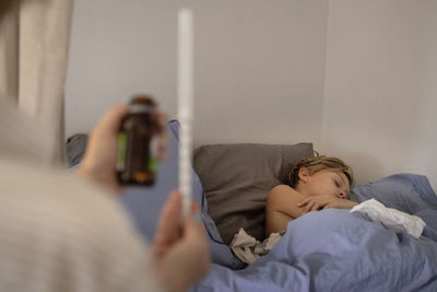 Mother applying medicine to sick boy