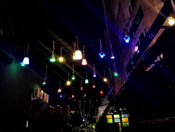 Low angle view of illuminated lights at night