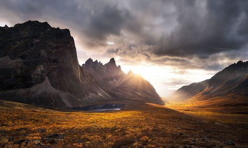 Scenic view of rocky mountains against sky during sunset