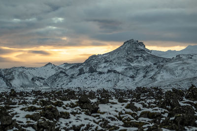 Scenic view of snowcapped mountains against sky during sunset