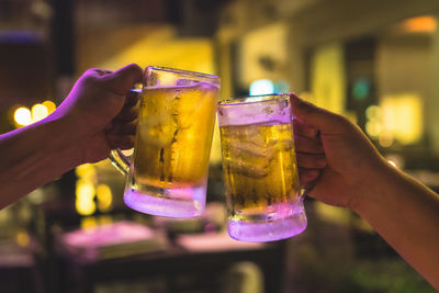 Close-up of hand holding beer glass