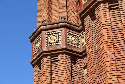 Low angle view of clock tower against sky in city