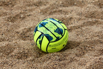 Green ball on sand