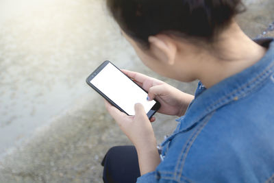 Midsection of man using mobile phone