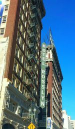 Low angle view of buildings against clear blue sky