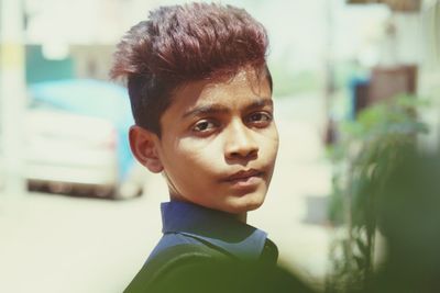 Close-up portrait of teenage boy standing outdoors