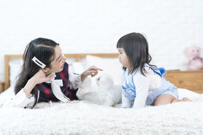 Rear view of women sitting on floor