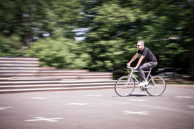 Man riding bicycle on road