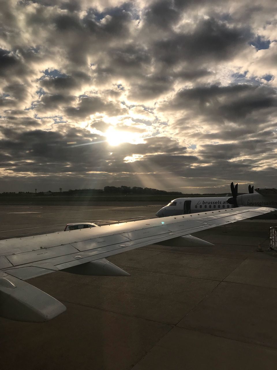 airplane, sky, cloud - sky, transportation, airport, journey, air vehicle, travel, sunset, runway, no people, airport runway, airplane wing, flying, day, nature, outdoors, commercial airplane