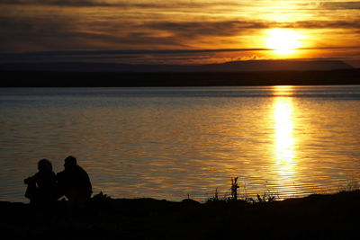 Couple enjoying the sunset at lake myvatn