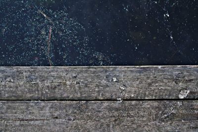 Directly above shot of lake and wooden plank