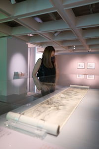 Woman standing on table at home