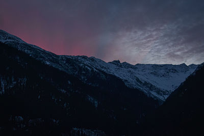 Scenic view of snowcapped mountains against sky at sunset