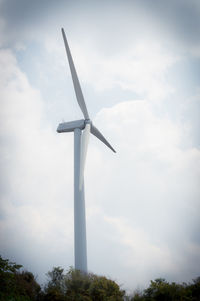 Low angle view of windmill against sky