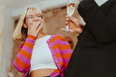 Low angle view of happy businesswoman laughing during event at convention center