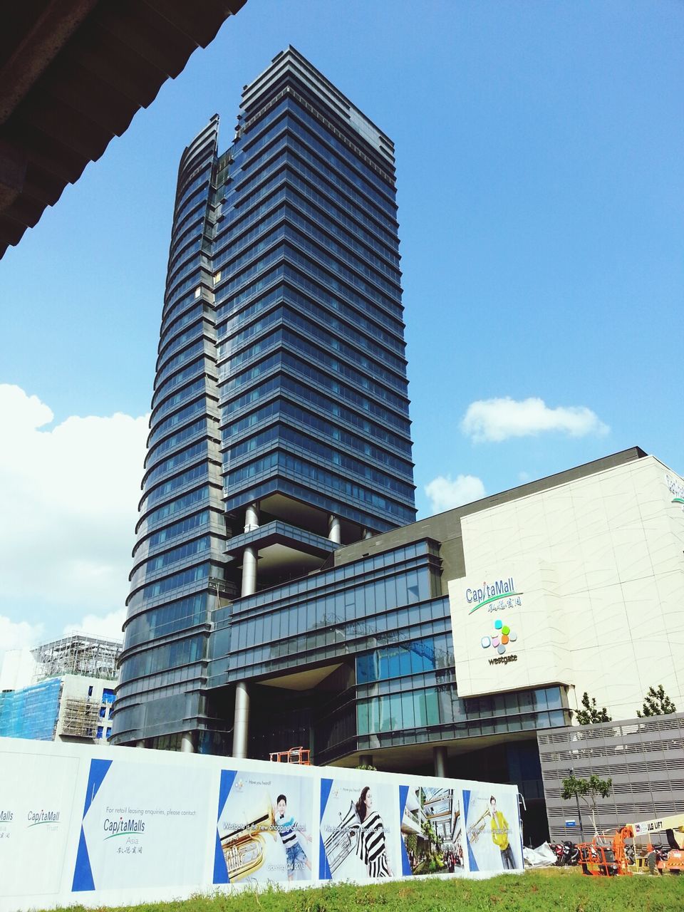 architecture, building exterior, built structure, low angle view, sky, building, city, tower, window, tall - high, modern, office building, blue, day, outdoors, no people, sunlight, exterior, brick wall, residential building