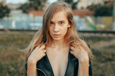 Portrait of young woman standing outdoors