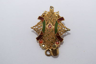 High angle view of ornate decoration on white background