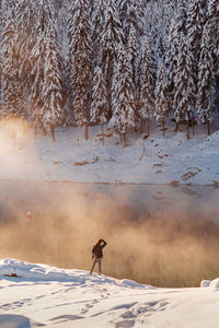 Person standing on snow covered land