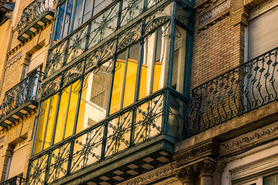 Low angle view of building and glass balconette