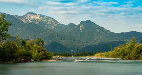 Scenic view of lake and mountains against sky