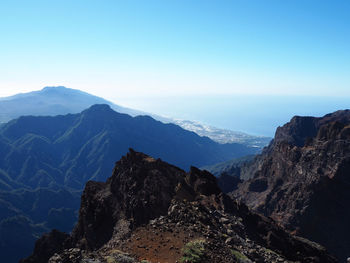 Scenic view of mountains against clear blue sky