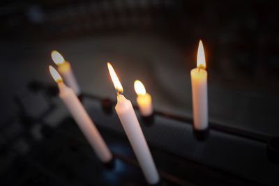 Close-up of burning candles in temple