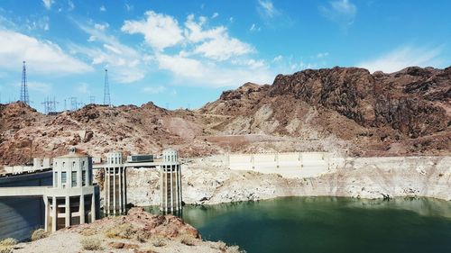 Panoramic view of dam by river against sky