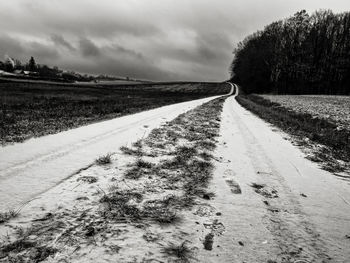 Empty road along countryside landscape