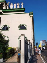 Low angle view of buildings against clear blue sky