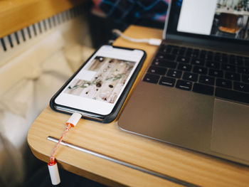 Mobile phone and laptop on desk in airplane