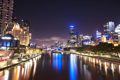 Illuminated city at waterfront