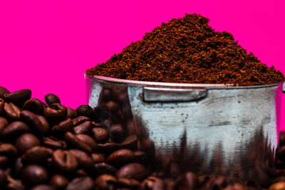 Close-up of bread on metal against pink background
