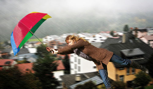 Full length of man flying against sky